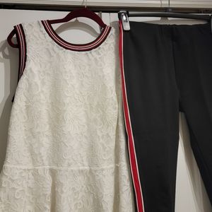 Cream lace top w/red, blk & silver trim. Pont knit blk pants w/red & wht stripes